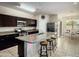 This spacious kitchen features granite countertops, a center island, stainless steel appliances, and sleek dark cabinetry at 4061 N 308Th Ln, Buckeye, AZ 85396