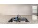 Close-up of a kitchen island with stainless steel double sink and granite countertop at 4061 N 308Th Ln, Buckeye, AZ 85396