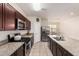 View of the kitchen featuring a central island, stainless steel appliances, and dark cabinets at 4061 N 308Th Ln, Buckeye, AZ 85396