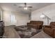 Cozy living room with plush carpet, neutral paint, and comfortable seating arrangement with good natural light at 4061 N 308Th Ln, Buckeye, AZ 85396