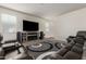 Well-lit living room featuring a television, speakers, and reclining sofas at 4061 N 308Th Ln, Buckeye, AZ 85396