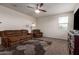 Comfortable living room featuring neutral walls, carpet flooring and couch with cozy seating and ceiling fan at 4061 N 308Th Ln, Buckeye, AZ 85396