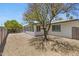 Lovely backyard with gravel, trees, and a sunroom extending from the house at 4347 E Catalina Cir, Mesa, AZ 85206