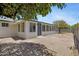 Charming backyard featuring a brick patio, large windows, and a cozy sunroom at 4347 E Catalina Cir, Mesa, AZ 85206