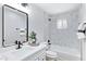 Bathroom with a single sink vanity and a tub-shower combo with marble tiling at 4347 E Catalina Cir, Mesa, AZ 85206
