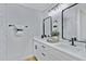 Bright bathroom featuring dual sinks, modern fixtures, and a decorative mirror at 4347 E Catalina Cir, Mesa, AZ 85206