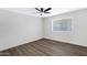 Neutral bedroom with a ceiling fan and large window, ready for personalization at 4347 E Catalina Cir, Mesa, AZ 85206