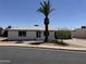 Charming single-story home featuring a well-manicured yard and a desert landscaped front yard at 4347 E Catalina Cir, Mesa, AZ 85206