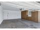 A clean garage with ample storage cabinets, two doors, and a visible garage door opener at 4347 E Catalina Cir, Mesa, AZ 85206