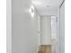 Well-lit hallway with wood-look flooring leads to a full bathroom with tub and shower at 4347 E Catalina Cir, Mesa, AZ 85206