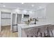 Bright kitchen features stainless steel appliances, quartz counters, and stylish bar stool seating at 4347 E Catalina Cir, Mesa, AZ 85206