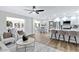 Open floor plan with modern white seating, breakfast bar, and wood-look flooring at 4347 E Catalina Cir, Mesa, AZ 85206