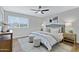 Comfortable main bedroom with a ceiling fan, plush bedding, and stylish decor at 4347 E Catalina Cir, Mesa, AZ 85206