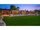 Beautiful backyard with a pool, lush artificial grass, and an outdoor kitchen, perfect for gatherings at 4518 E Solano Dr, Phoenix, AZ 85018