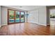 Inviting bedroom with hardwood floors, a TV, and doors leading to the pool at 4518 E Solano Dr, Phoenix, AZ 85018