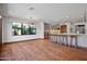 Spacious great room with bar seating at the kitchen counter, tile floors, and lots of light at 4518 E Solano Dr, Phoenix, AZ 85018