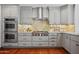 Modern kitchen features stainless steel appliances, double oven, custom cabinets, and stylish backsplash at 4518 E Solano Dr, Phoenix, AZ 85018