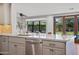 Bright kitchen featuring stainless steel appliances, marble countertops and views of the pool and backyard at 4518 E Solano Dr, Phoenix, AZ 85018