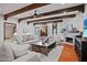 Cozy living room with wood beams, a fireplace, and access to the outdoor courtyard at 4518 E Solano Dr, Phoenix, AZ 85018