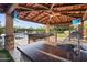 Entertainers dream outdoor bar under a covered patio with ceiling fan and TV at 4518 E Solano Dr, Phoenix, AZ 85018