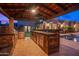 Outdoor kitchen with a grill, bar seating, and a TV, creating the perfect outdoor entertainment space at 4518 E Solano Dr, Phoenix, AZ 85018