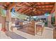 Beautiful outdoor kitchen with bar seating, a built-in grill, and a covered patio at 4518 E Solano Dr, Phoenix, AZ 85018