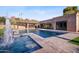 Backyard oasis boasts a sparkling pool, spa, covered bar and picturesque mountain views at 4518 E Solano Dr, Phoenix, AZ 85018