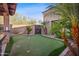 Outdoor putting green with multiple holes, surrounded by mature landscaping at 4518 E Solano Dr, Phoenix, AZ 85018