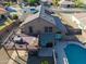 Aerial view of a brown home with a large wooden deck, a pool, and desert landscaping at 4547 E Buist Ave, Phoenix, AZ 85044
