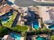 Aerial view of a backyard with a pool, landscaping, a turf area, and views of neighboring pools at 4547 E Buist Ave, Phoenix, AZ 85044