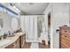 Bathroom with double sinks, hardwood floor, and walk-in shower, complete with modern fixtures at 4547 E Buist Ave, Phoenix, AZ 85044