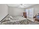Cozy bedroom with a bed, wooden dresser, and a window at 4547 E Buist Ave, Phoenix, AZ 85044