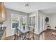 Bright dining area featuring a tile-top table, shuttered windows, and access to the outdoors at 4547 E Buist Ave, Phoenix, AZ 85044