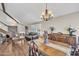 Spacious living room featuring a staircase, chandelier, and hardwood flooring at 4547 E Buist Ave, Phoenix, AZ 85044
