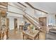 Inviting living room boasting an open floor plan, exposed beams, and an elegant staircase at 4547 E Buist Ave, Phoenix, AZ 85044