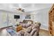 Comfortable living room with modern ceiling fan, painting and cozy furniture at 4547 E Buist Ave, Phoenix, AZ 85044
