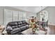 Inviting living room with a large window, sofa, and hardwood flooring at 4547 E Buist Ave, Phoenix, AZ 85044