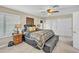 Bedroom showcasing a ceiling fan, shuttered windows, and a spacious closet at 4547 E Buist Ave, Phoenix, AZ 85044