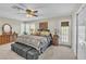 Main bedroom with ceiling fan, shutters, and access to backyard at 4547 E Buist Ave, Phoenix, AZ 85044