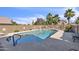 Backyard pool with blue accents, surrounded by a block wall for privacy at 4547 E Buist Ave, Phoenix, AZ 85044
