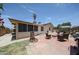 Inviting backyard with red brick patio, outdoor seating, barbecue, mature trees and a screened in porch at 4623 W Solano S Dr # South, Glendale, AZ 85301