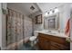 Cozy bathroom featuring a vanity, framed mirror, shower with curtain and toilet at 4623 W Solano S Dr # South, Glendale, AZ 85301