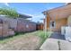 Backyard featuring a mix of concrete and grass, surrounded by block fencing at 4632 W Marlette Ave, Glendale, AZ 85301
