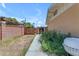 Backyard view with a walkway by a block fence, plus some overgrown landscaping at 4632 W Marlette Ave, Glendale, AZ 85301
