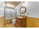 Bathroom features a vanity with a decorative mirror and a shower with glass doors at 4632 W Marlette Ave, Glendale, AZ 85301