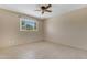 Bright bedroom with neutral paint, ceiling fan, and a window offering ample natural light at 4632 W Marlette Ave, Glendale, AZ 85301