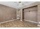 Bedroom with wood-look flooring, ceiling fan, and a closet at 4632 W Marlette Ave, Glendale, AZ 85301