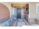 Detailed front porch featuring decorative tile accents, a secure metal door, and a unique stone base at 4632 W Marlette Ave, Glendale, AZ 85301