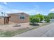 Inviting home with desert landscaping, rock feature, and mature trees at 4632 W Marlette Ave, Glendale, AZ 85301