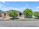 Inviting home exterior with desert landscaping, mature trees, and a rock feature at 4632 W Marlette Ave, Glendale, AZ 85301